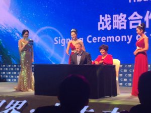 Icon Group CEO Mark Middleton signing partnership documents with Yibai Healthcare